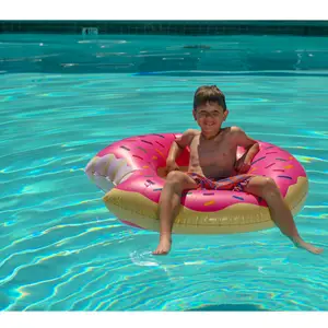 Boy sitting in a pool float after the pool had been refilled.