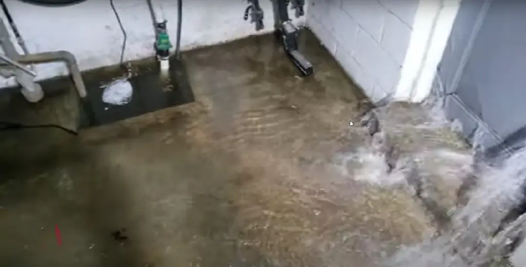 Water rushing through basement door faster than the sump pump can pump the water out.